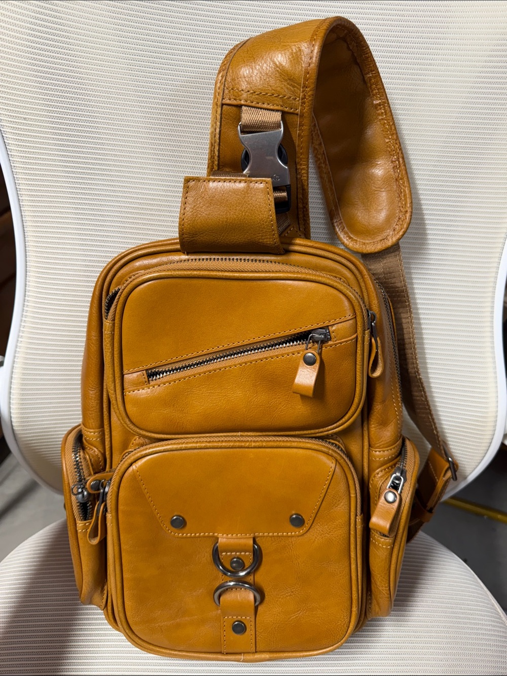 100% real leather sling bag with multiple pockets smells amazing